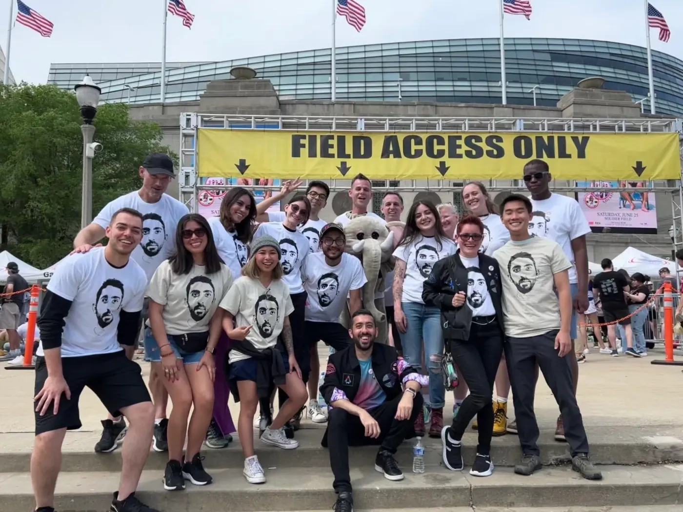 A group photo of friends wearing Jimmy Dushku face t-shirts, with Jimmy in the middle