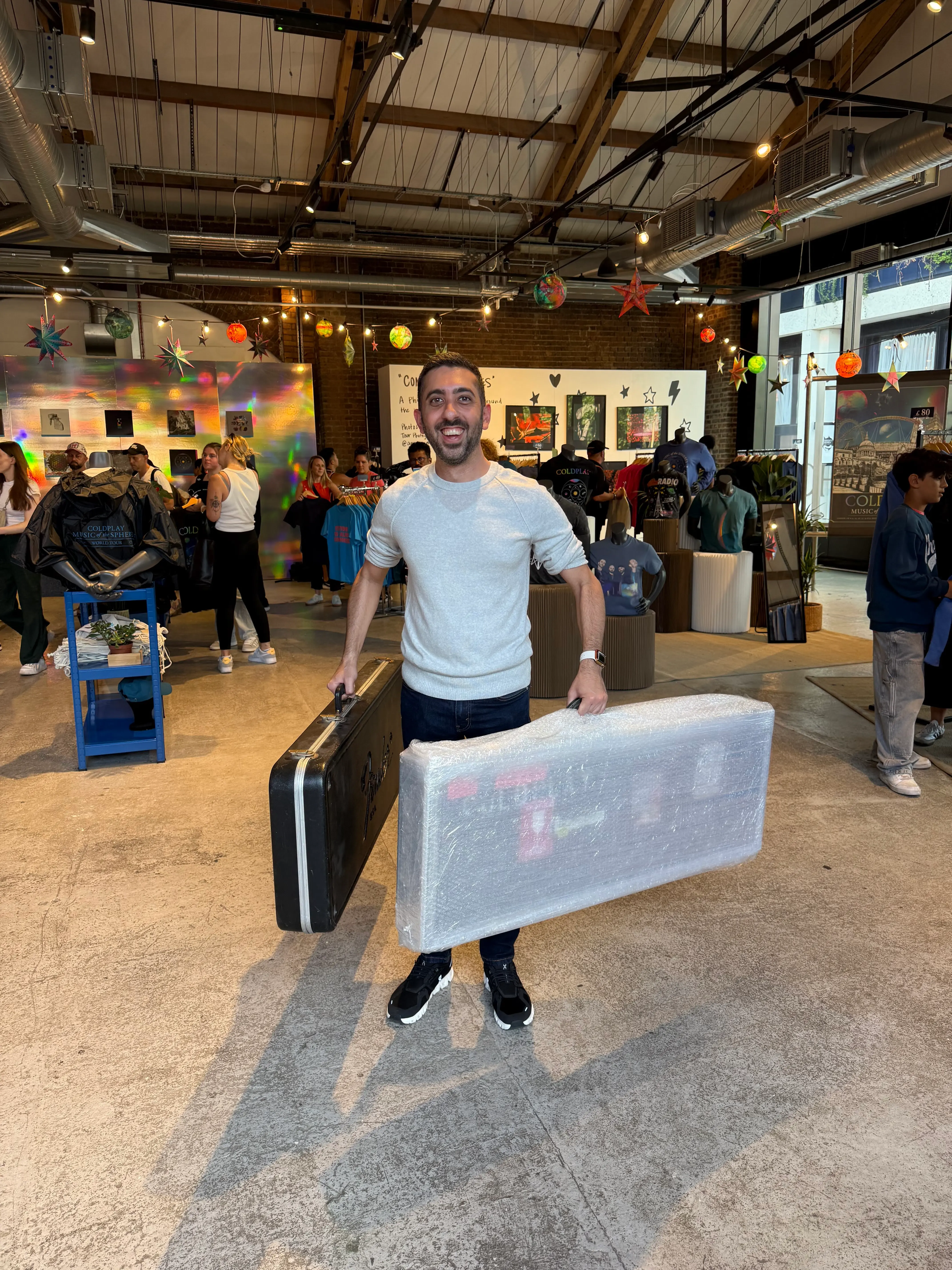 Carrying two pieces of Coldplay history through a packed pop-up shop