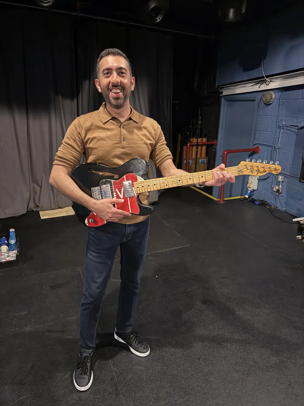 Jimmy Dushku holding Jonny Buckland's Viva la Vida era guitar from Oz's collection