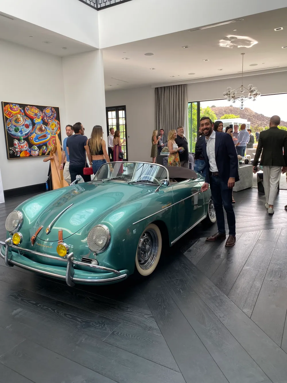 Jimmy Dushku next to a Porsche 356 inside the Bel Air estate's living room
