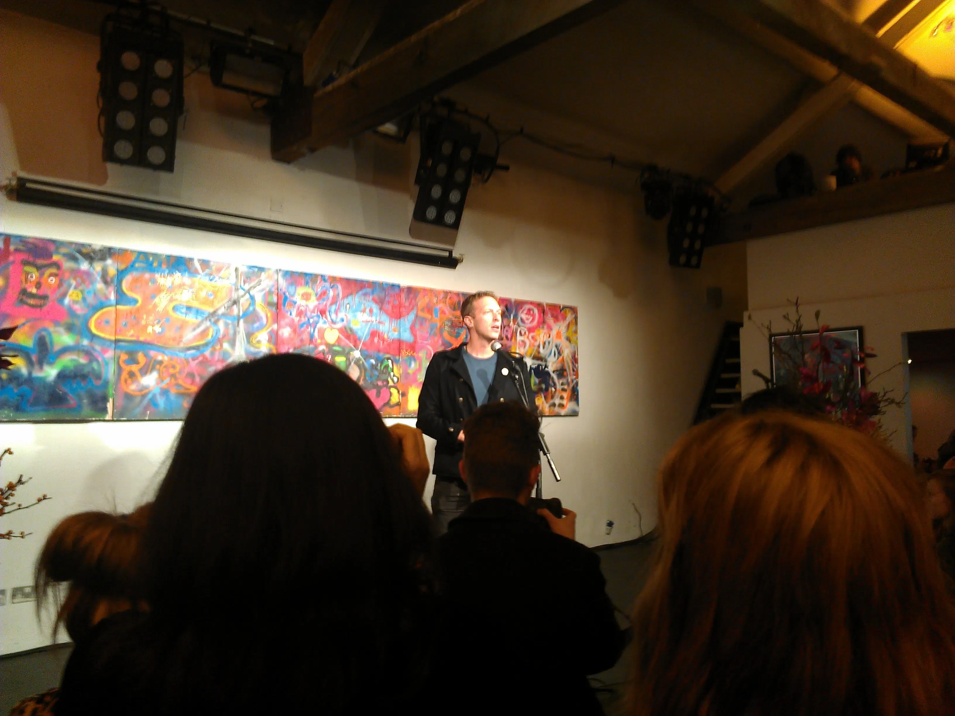 Chris Martin giving a speech at the Mylo Xyloto artwork exhibition at Proud Galleries