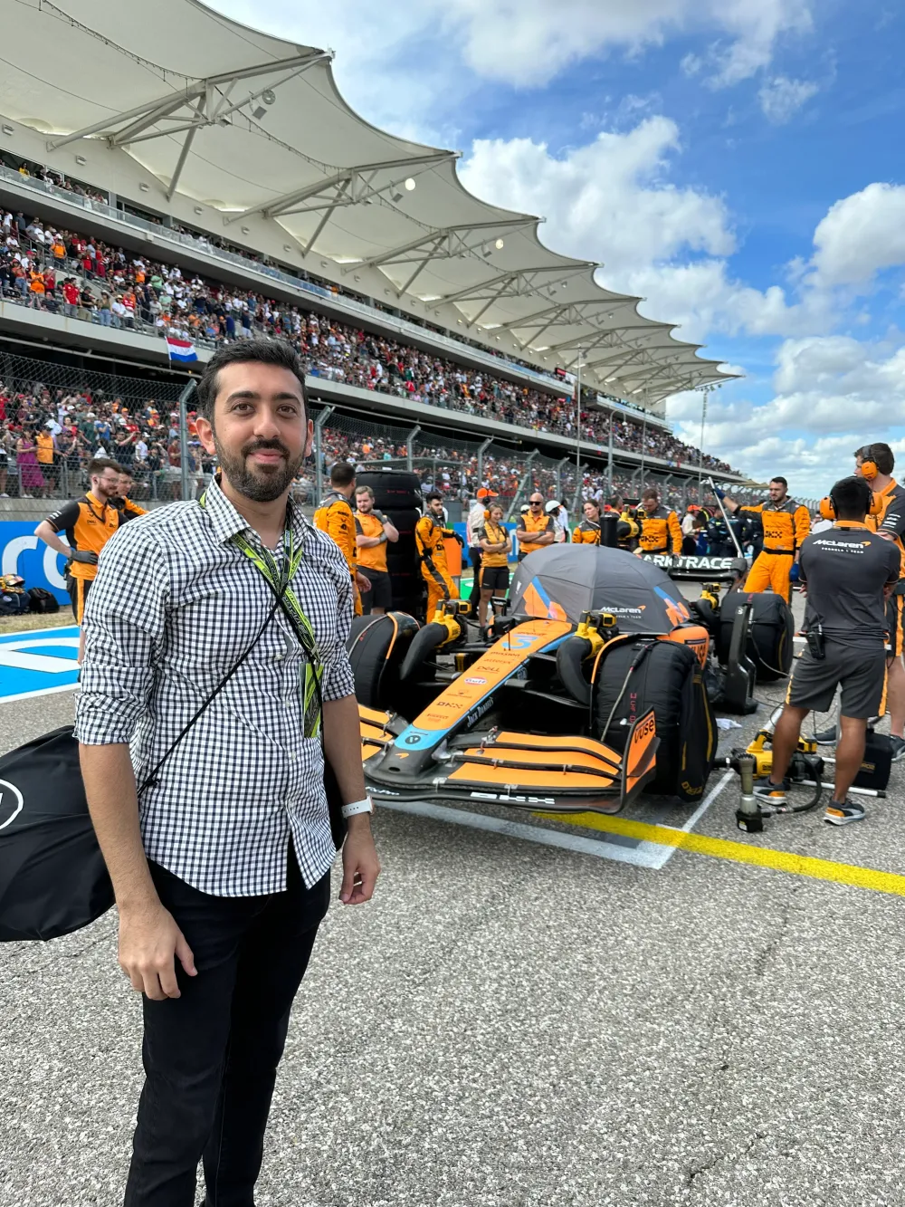 Jimmy Dushku on the starting grid in front of Daniel Ricciardo's McLaren