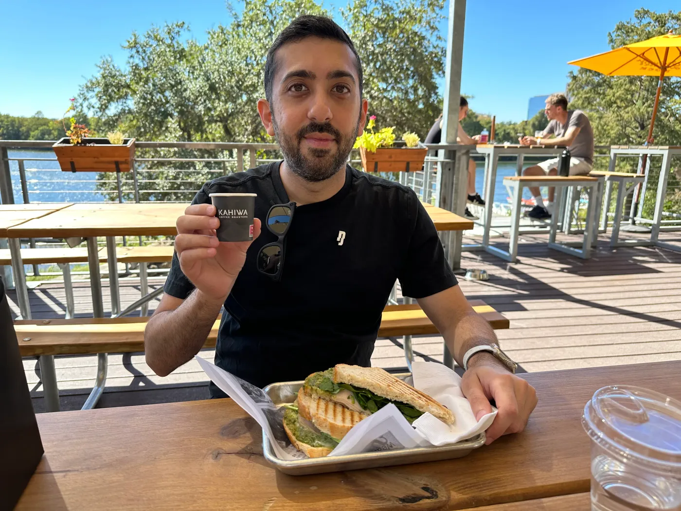 Jimmy Dushku having Kahiwa Coffee and a sandwich by the river