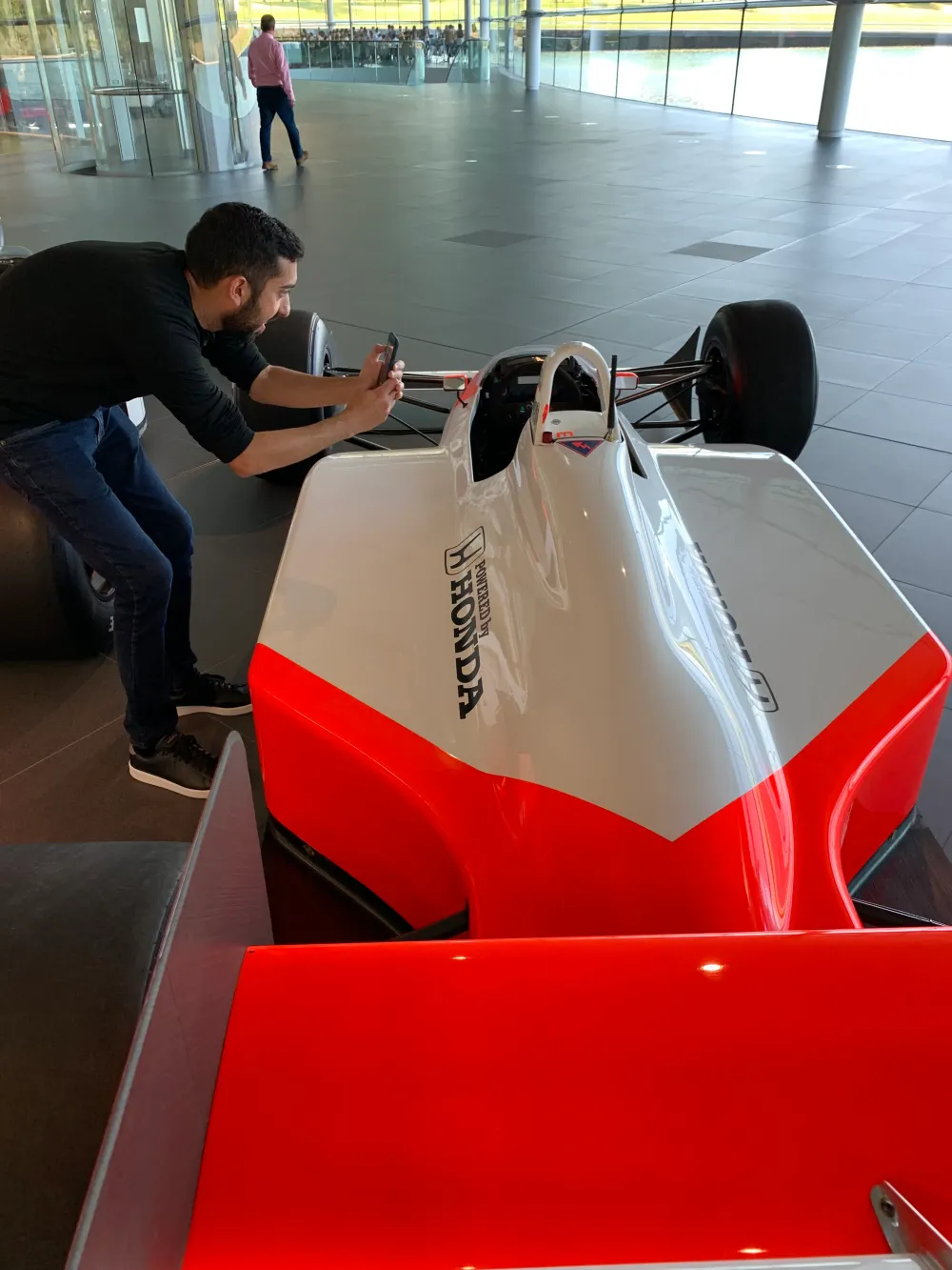Jimmy Dushku leaning in to photograph the cockpit of a McLaren Honda Formula 1 car