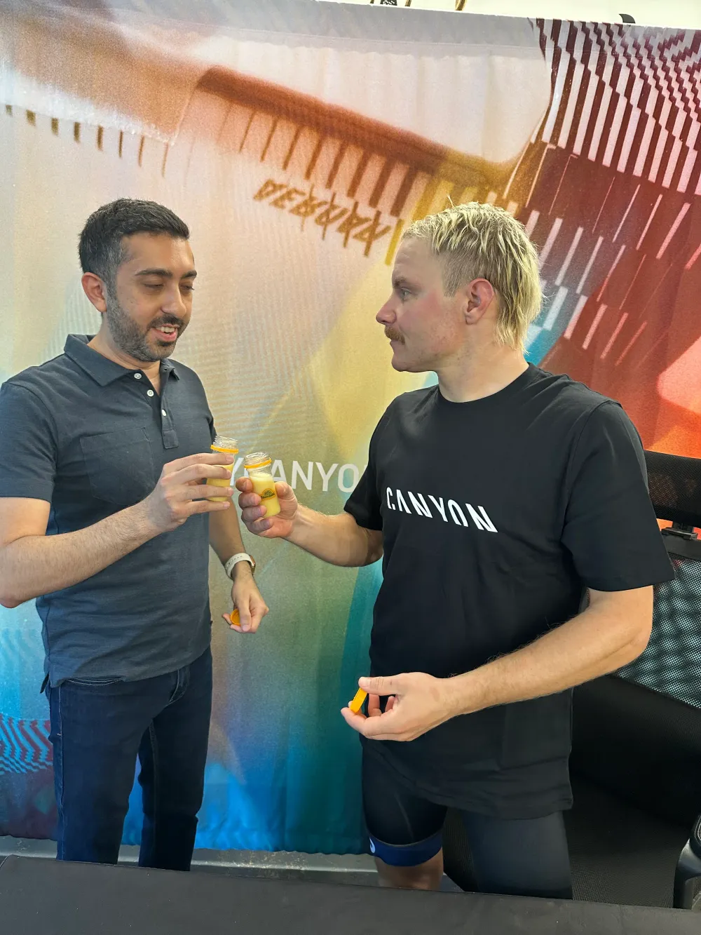 Jimmy Dushku and Valtteri Bottas cheersing ginger shots