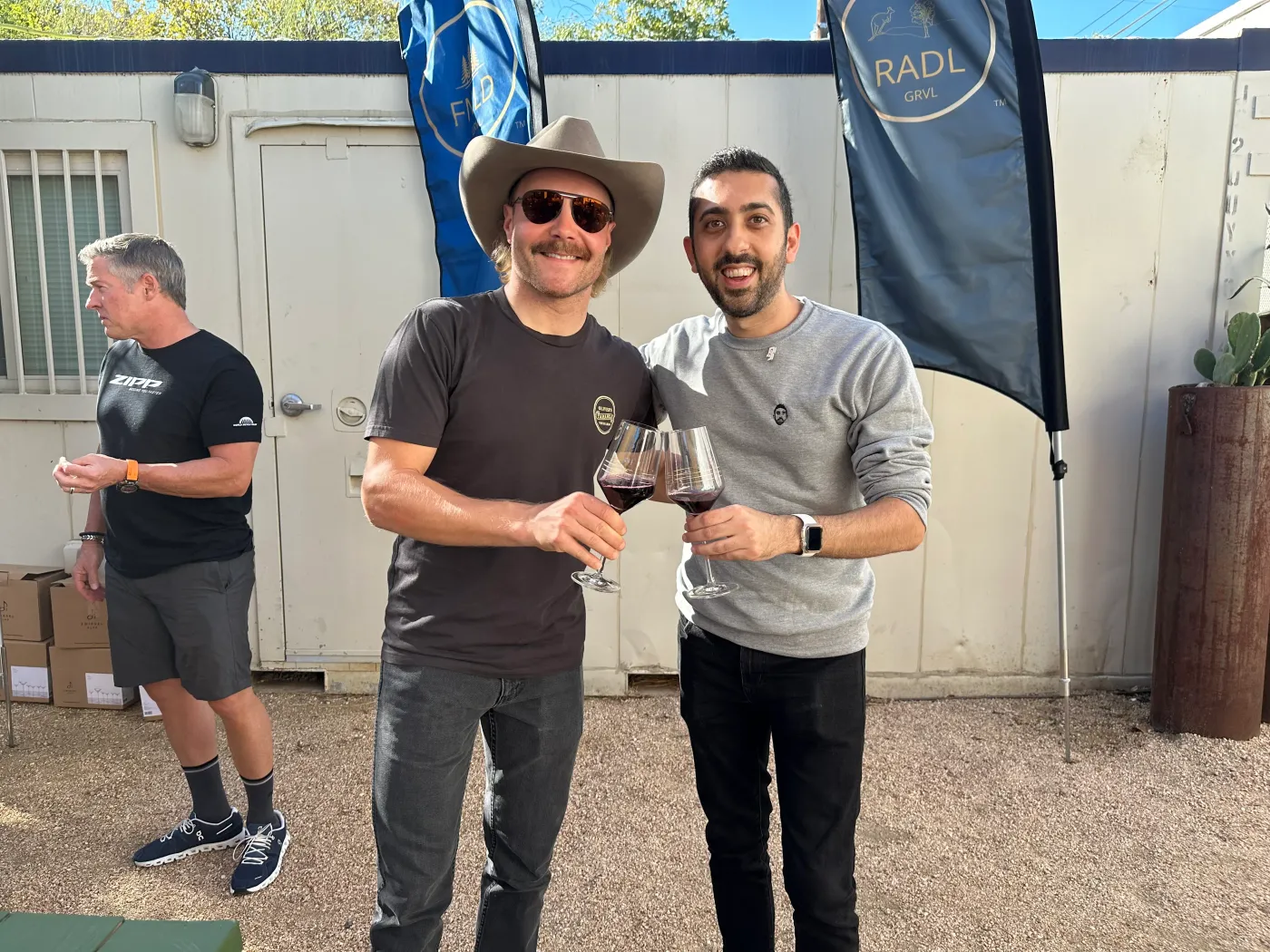 Jimmy Dushku toasting a glass of Ihana wine with Valtteri Bottas